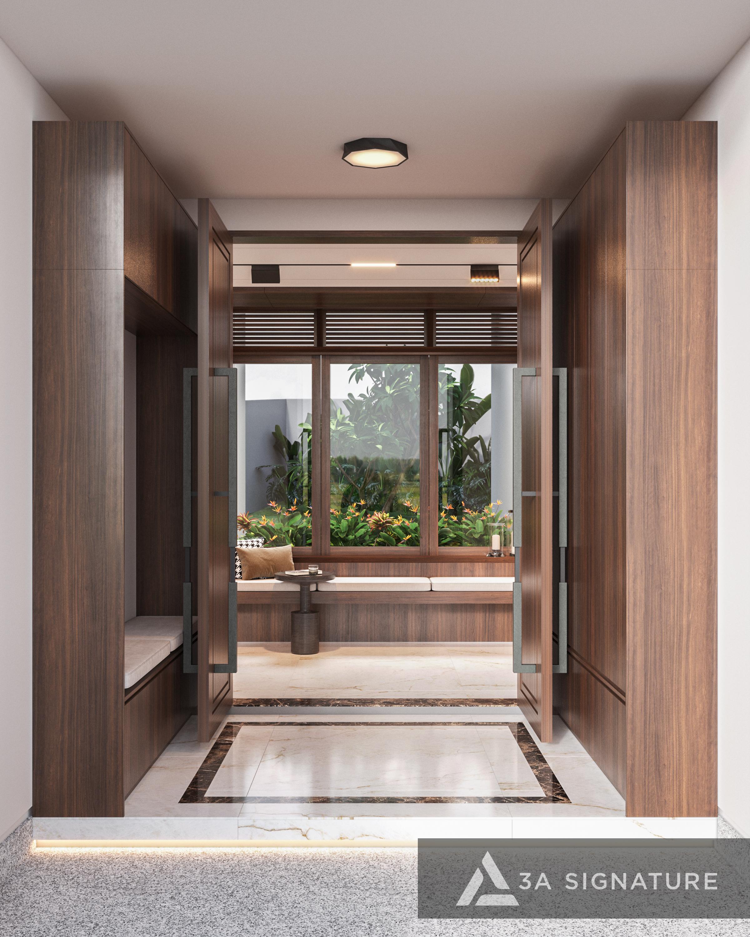 Lối vào biệt thự sử dụng cửa gỗ biệt thự hiện đại cùng tủ gỗ đồng bộ, mở tầm nhìn ra sân vườn xanh mát qua ô cửa lớn, tạo không gian tinh tế và ấm áp.